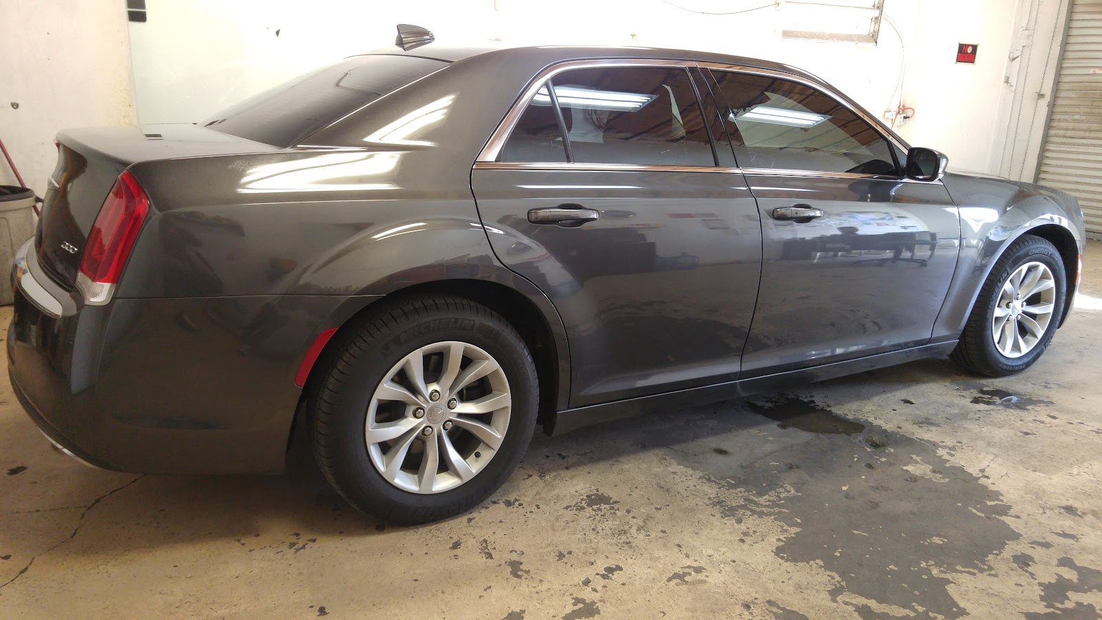 Gray Chrysler 300 rear three-quarter view with tinted windows in the shop