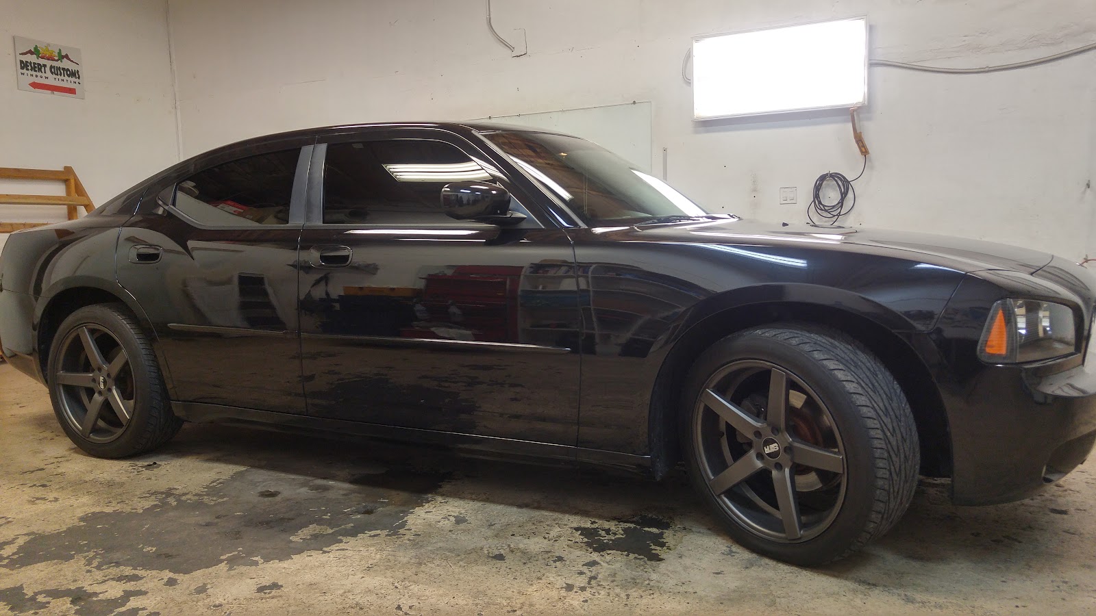 Black Dodge Charger with tinted windows in the Desert Customs tint shop